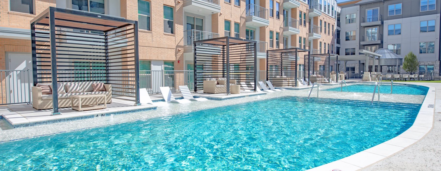 a swimming pool in front of a row of houses