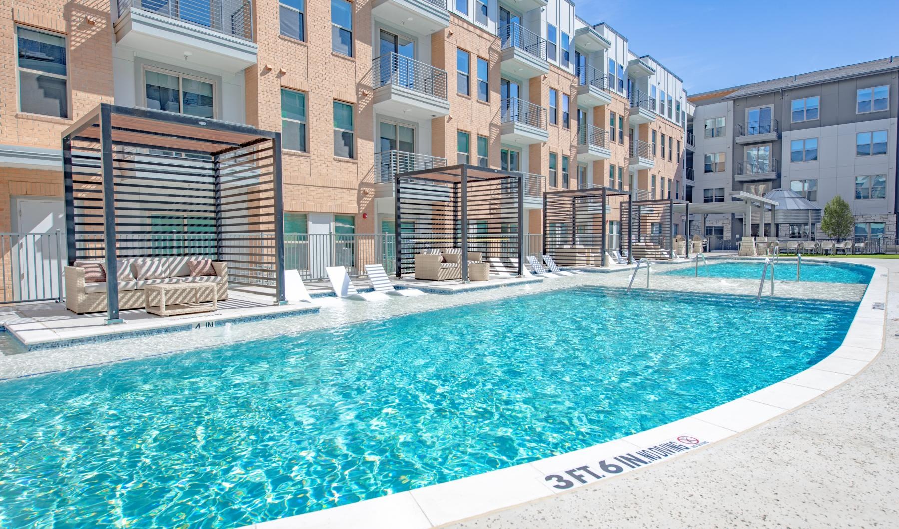 Sparkling swimming pool a swimming pool in front of a row of houses