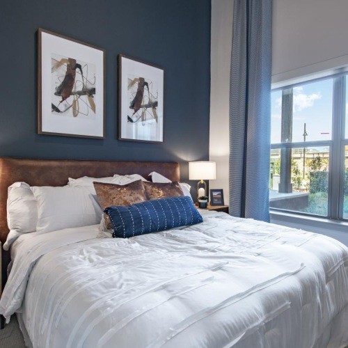 Relax and recharge in beautiful and spacious bedrooms a bedroom with a large window