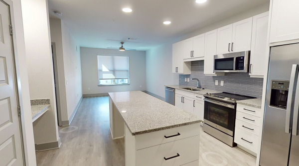 Kitchen with custom cabinets and upgraded, stainless-steel appliances at our apartments on Alma Dr near Plano, TX Residences