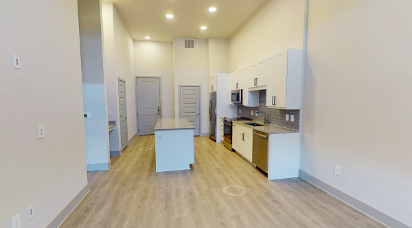 Kitchen with wood-style flooring at our Fairview, TX apartments Residences