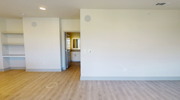 Open-concept floor plan with wood-style flooring at our apartments near Allen, TX Residences
